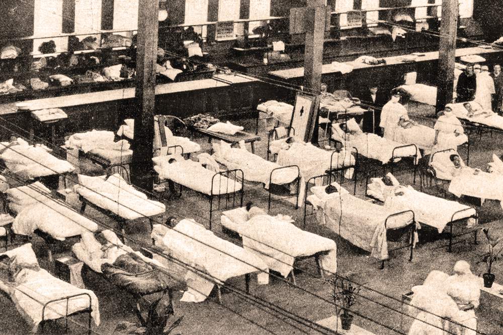 Photo: Hospital beds in Great Hall, Melbourne Exhibition Centre, Carlton, during the influenza pandemic, 1919. Photographer unknown. Courtesy of Museum Victoria