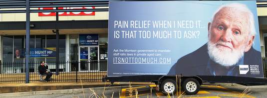 The ‘It’s not too much’ campaign billboard outside Federal Health and Aged Care Minister Greg Hunt’s Flinders electorate office in Sommerville.