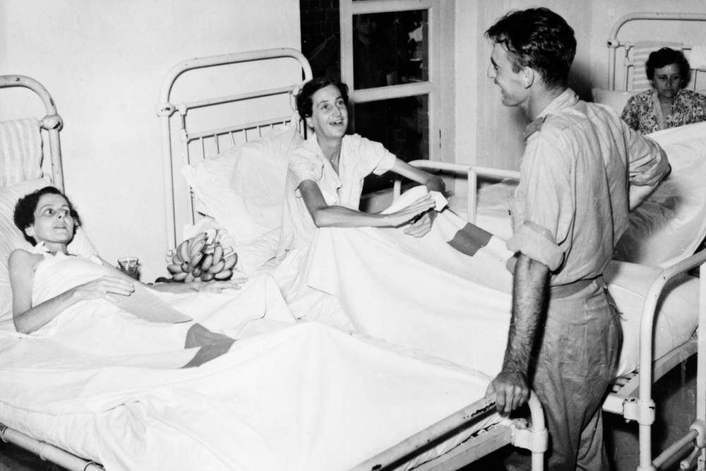 Two members of the Australian Army Nursing Service, Sister Jean Keer (Jenny) Greer of Petersham, NSW (left), and Sister Betty Jeffrey of East Malvern, VIC, who were for three and a half years prisoners of war in japanese hands in sumatra, talking with an Australian soldier. The sisters were recovering from malnutrition in the dutch hospital.