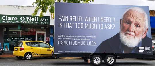 The ‘It’s not too much’ campaign billboard outside Federal Shadow Minister for Senior Australians and Aged care Services Clare O’Neil’s Hotham electorate office in Clayton.